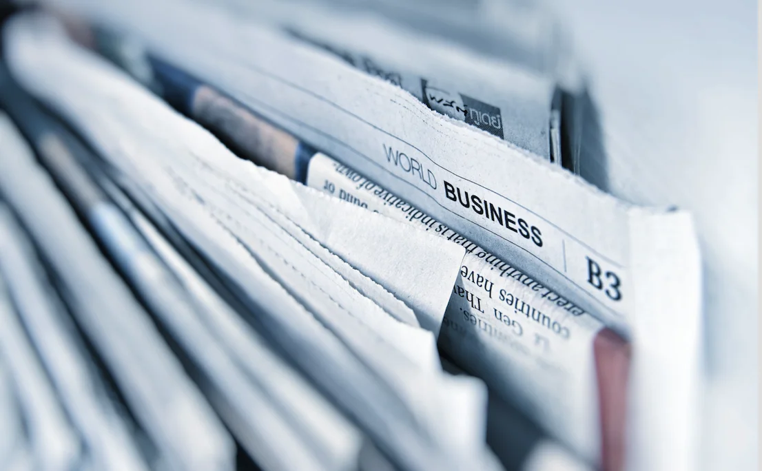 A stack of papers relating to business all filed upright.